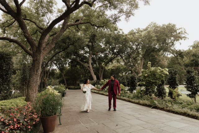 A bride and groom in their wedding attire on their wedding day take their romantic and natural documentary styled photos at the Dallas Arboretum.