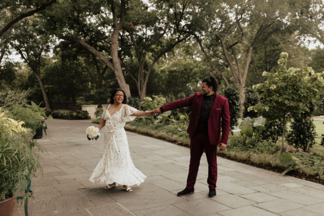 A bride and groom in their wedding attire on their wedding day take their romantic and natural documentary styled photos at the Dallas Arboretum.