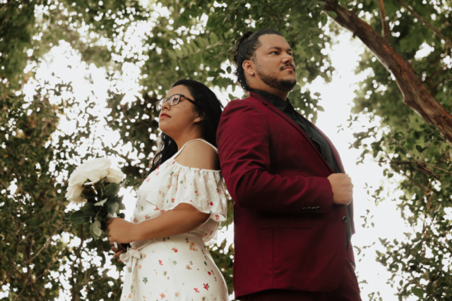A bride and groom in their wedding attire on their wedding day take their romantic and natural documentary styled photos at the Dallas Arboretum.