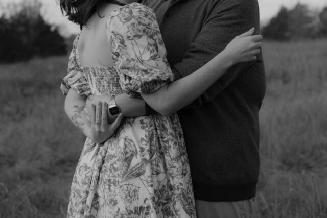 A couple in neutral attire run in an open field take their engagement photos at sunrise by Hannah Lylene Photography.