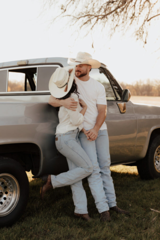 A couple in neutral attire in an open field in Fort Worth, Texas take their documentary style wedding engagement photos.