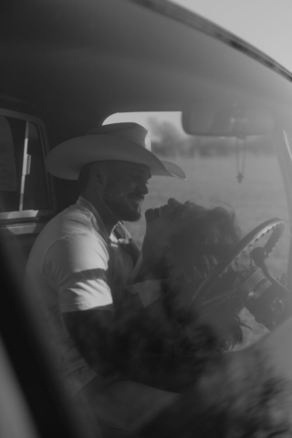 A couple in neutral attire in an open field in Fort Worth, Texas take their documentary style wedding engagement photos.