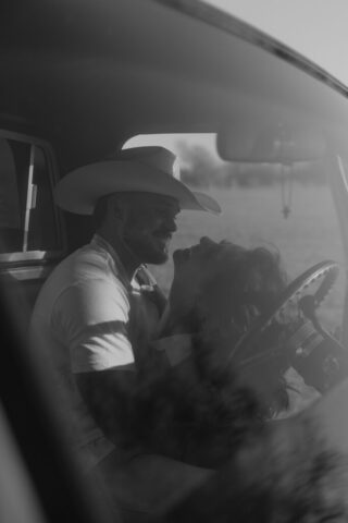 A couple in neutral attire in an open field in Fort Worth, Texas take their documentary style wedding engagement photos.