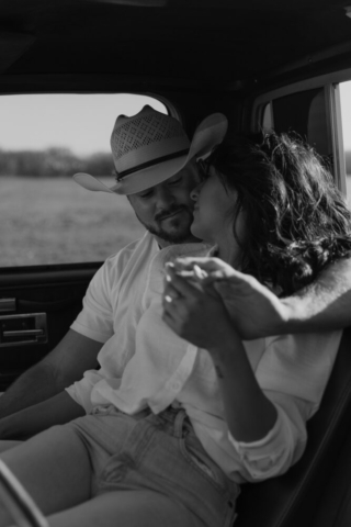 A couple in neutral attire in an open field in Fort Worth, Texas take their documentary style wedding engagement photos.