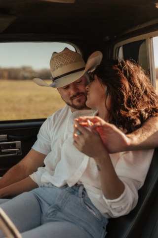 A couple in neutral attire in an open field in Fort Worth, Texas take their documentary style wedding engagement photos.