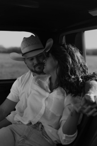 A couple in neutral attire in an open field in Fort Worth, Texas take their documentary style wedding engagement photos.