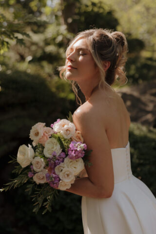 A young bride and groom at the Fort Worth Botanical Gardens on their intimate elopement wedding day in Fort Worth, Texas.