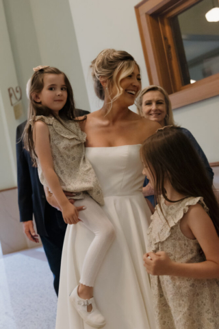 A young bride and groom at the Tarrant County Courthouse on their intimate elopement wedding day in Fort Worth, Texas.