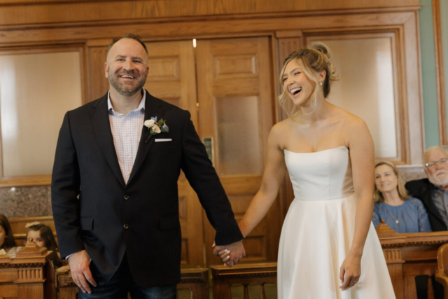 A young bride and groom at the Tarrant County Courthouse on their intimate elopement wedding day in Fort Worth, Texas.