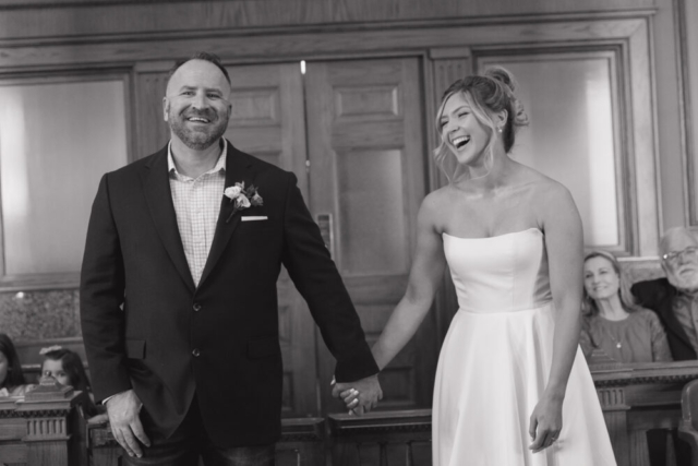 A young bride and groom at the Tarrant County Courthouse on their intimate elopement wedding day in Fort Worth, Texas.