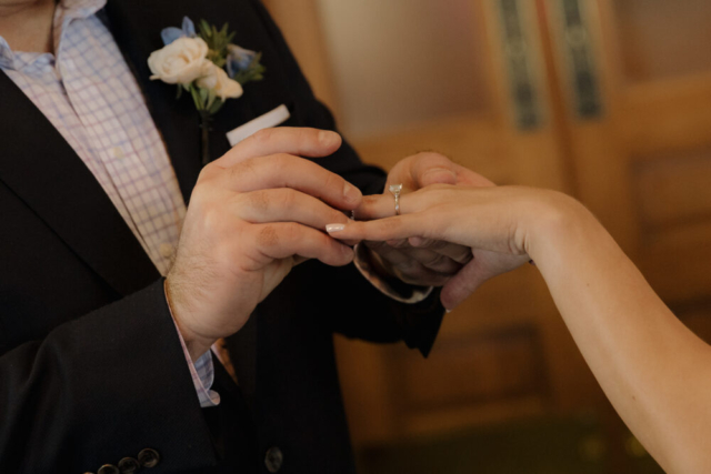 A young bride and groom at the Tarrant County Courthouse on their intimate elopement wedding day in Fort Worth, Texas.