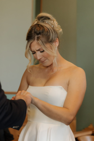 A young bride and groom at the Tarrant County Courthouse on their intimate elopement wedding day in Fort Worth, Texas.