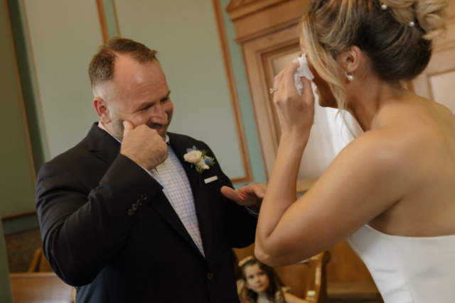 A young bride and groom at the Tarrant County Courthouse on their intimate elopement wedding day in Fort Worth, Texas.