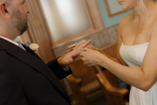 A young bride and groom at the Tarrant County Courthouse on their intimate elopement wedding day in Fort Worth, Texas.