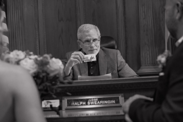 A young bride and groom at the Tarrant County Courthouse on their intimate elopement wedding day in Fort Worth, Texas.