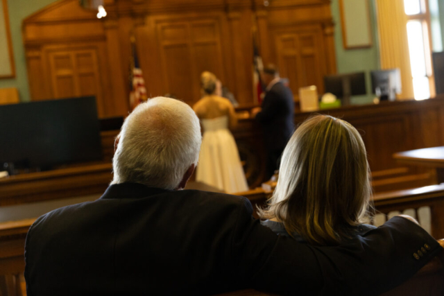 A young bride and groom at the Tarrant County Courthouse on their intimate elopement wedding day in Fort Worth, Texas.