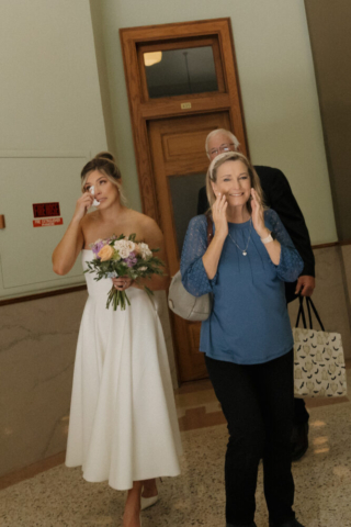 A young bride and groom at the Tarrant County Courthouse on their intimate elopement wedding day in Fort Worth, Texas.