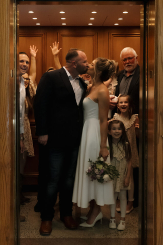 A young bride and groom at the Tarrant County Courthouse on their intimate elopement wedding day in Fort Worth, Texas.