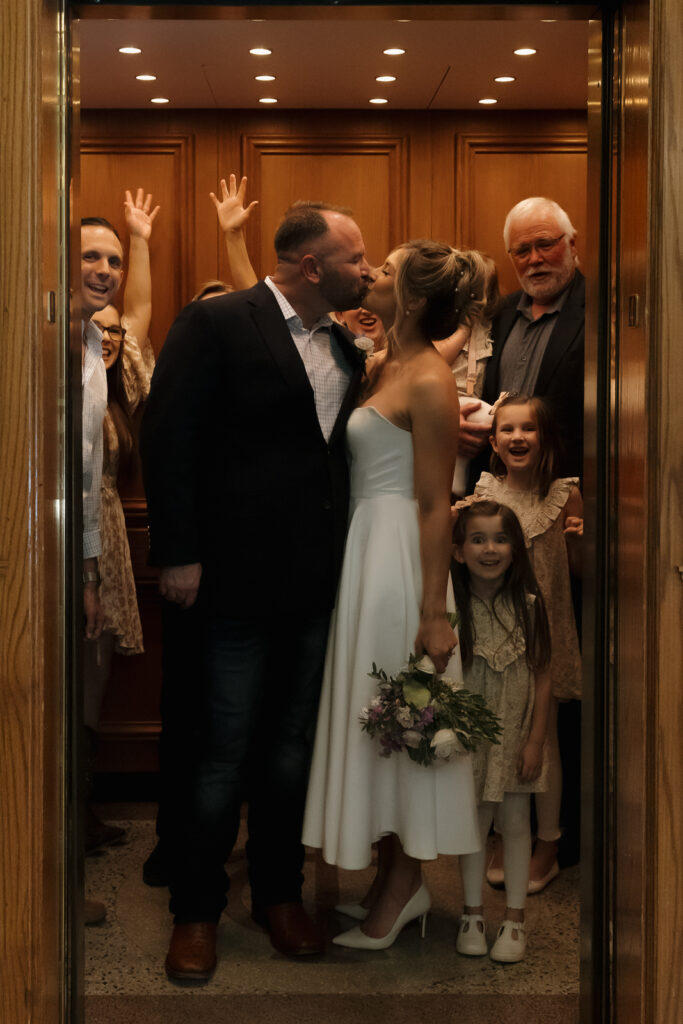 A young bride and groom at the Tarrant County Courthouse on their intimate elopement wedding day in Fort Worth, Texas.