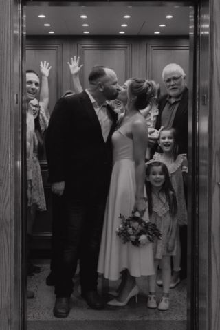 A young bride and groom at the Tarrant County Courthouse on their intimate elopement wedding day in Fort Worth, Texas.