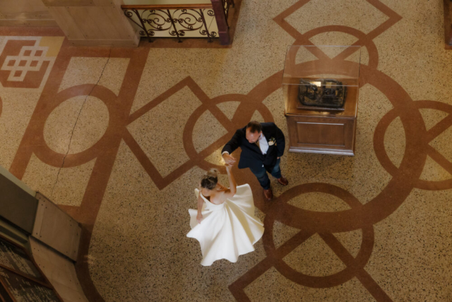 A young bride and groom at the Tarrant County Courthouse on their intimate elopement wedding day in Fort Worth, Texas.