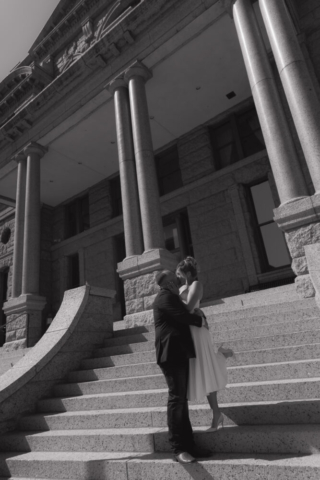 A young bride and groom at the Tarrant County Courthouse on their intimate elopement wedding day in Fort Worth, Texas.