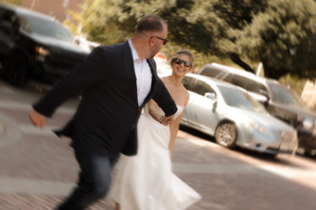 A young bride and groom at the Tarrant County Courthouse on their intimate elopement wedding day in Fort Worth, Texas.