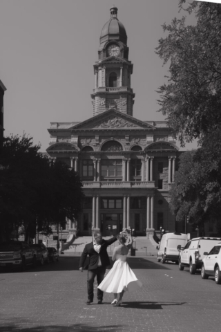 A young bride and groom at the Tarrant County Courthouse on their intimate elopement wedding day in Fort Worth, Texas.