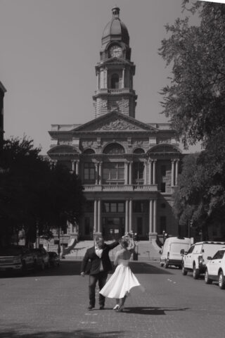 A young bride and groom at the Tarrant County Courthouse on their intimate elopement wedding day in Fort Worth, Texas.