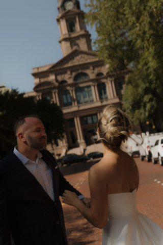 A young bride and groom at the Tarrant County Courthouse on their intimate elopement wedding day in Fort Worth, Texas.