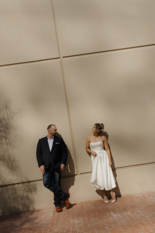 A young bride and groom at the Tarrant County Courthouse on their intimate elopement wedding day in Fort Worth, Texas.