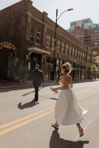 A young bride and groom at the Tarrant County Courthouse on their intimate elopement wedding day in Fort Worth, Texas.