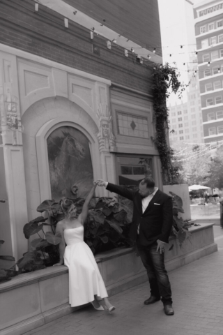 A young bride and groom at the Tarrant County Courthouse on their intimate elopement wedding day in Fort Worth, Texas.