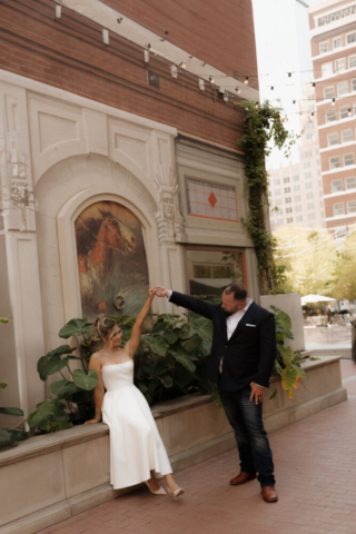 A young bride and groom at the Tarrant County Courthouse on their intimate elopement wedding day in Fort Worth, Texas.