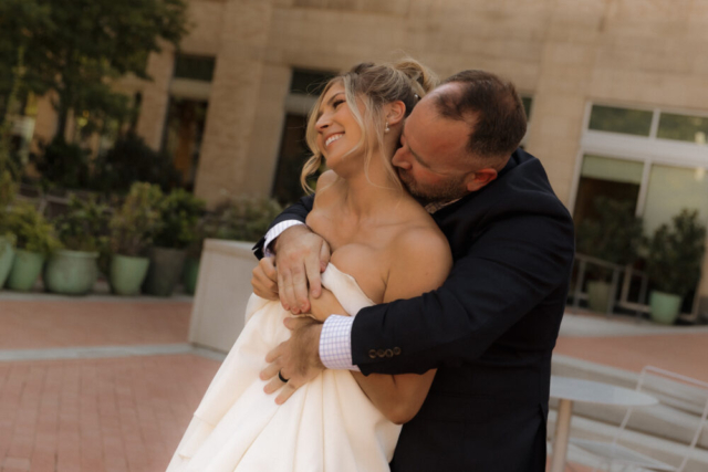 A young bride and groom at the Tarrant County Courthouse on their intimate elopement wedding day in Fort Worth, Texas.