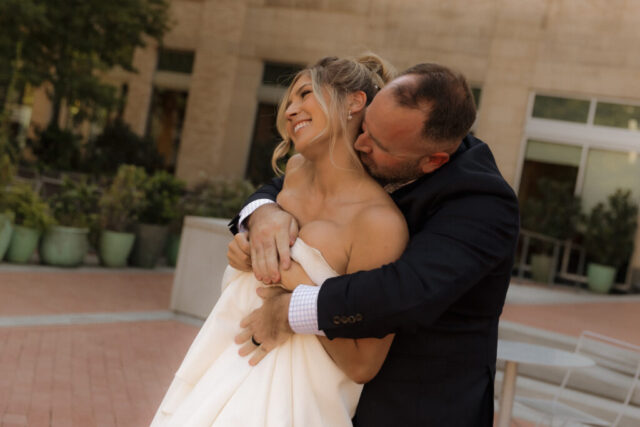 A young bride and groom at the Tarrant County Courthouse on their intimate elopement wedding day in Fort Worth, Texas.