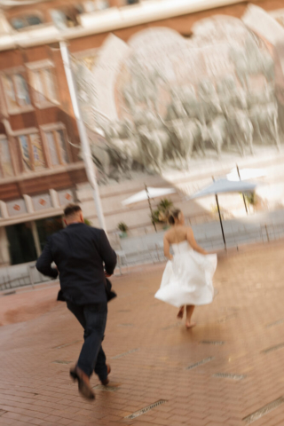 A young bride and groom at the Tarrant County Courthouse on their intimate elopement wedding day in Fort Worth, Texas.