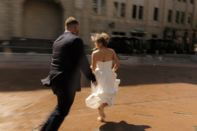 A young bride and groom at the Tarrant County Courthouse on their intimate elopement wedding day in Fort Worth, Texas.