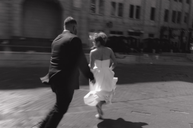 A young bride and groom at the Tarrant County Courthouse on their intimate elopement wedding day in Fort Worth, Texas.