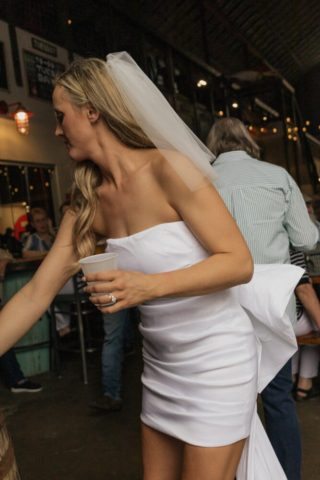 A bride and groom have a candid documentary elopement wedding ceremony in Dallas, Texas, followed by modern classy bridal portraits and candid photos while interacting with their reception guests.