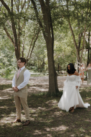 A young bride and groom at their cinematic, intimate outdoor wedding ceremony have candid photos taken of their wedding decor and their guests in the DFW area by Texas wedding photographer Hannah Lylene Photography.