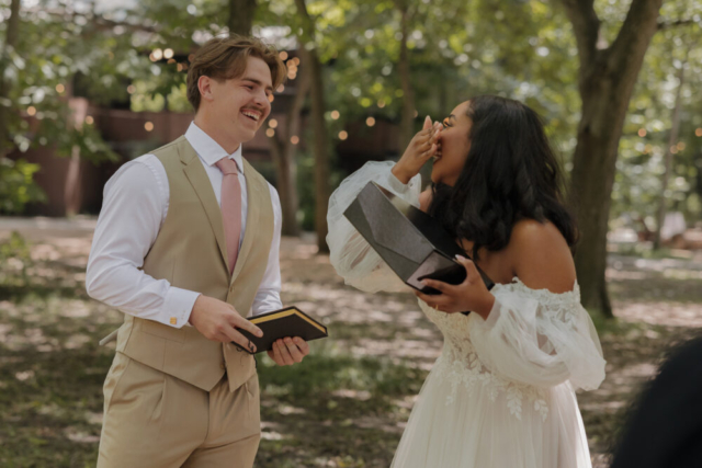 A young bride and groom at their cinematic, intimate outdoor wedding ceremony have candid photos taken of their wedding decor and their guests in the DFW area by Texas wedding photographer Hannah Lylene Photography.