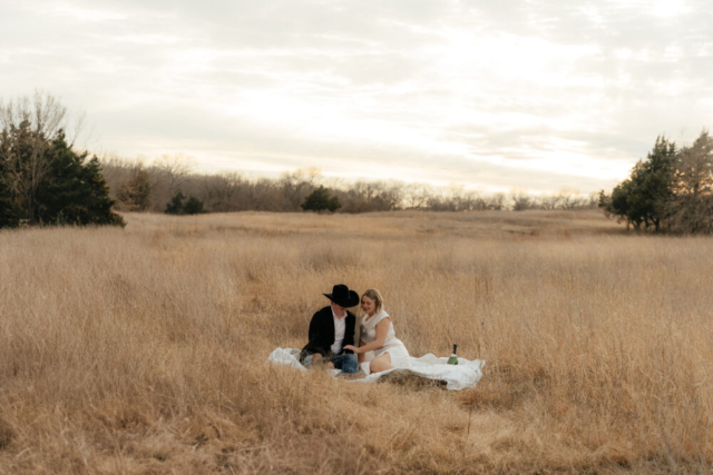 A couple in neutral attire run in an open field take their cinematic and documentary style engagement photos by Hannah Lylene Photography.