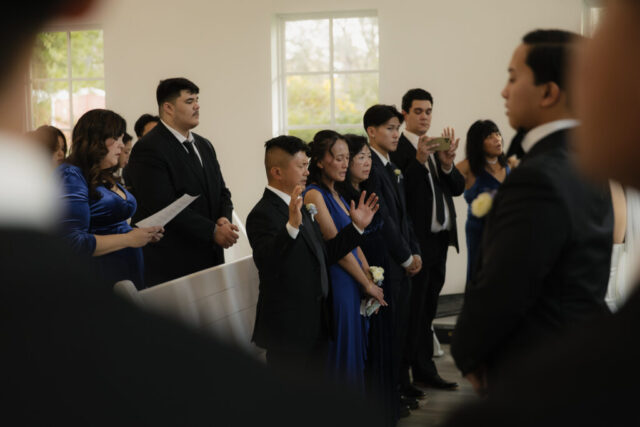 A bride and groom have a candid documentary elopement wedding ceremony in Houston, Texas at the Addison Woods Wedding Venue followed by modern classy bridal portraits and candid photos while interacting with their reception guests.