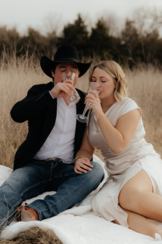 A couple in neutral attire run in an open field take their cinematic and documentary style engagement photos by Hannah Lylene Photography.