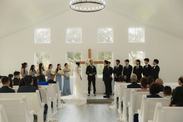 A bride and groom have a candid documentary elopement wedding ceremony in Houston, Texas at the Addison Woods Wedding Venue followed by modern classy bridal portraits and candid photos while interacting with their reception guests.