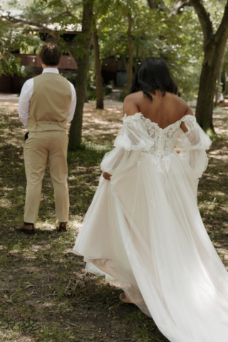 A young bride and groom at their cinematic, intimate outdoor wedding ceremony have candid photos taken of their wedding decor and their guests in the DFW area by Texas wedding photographer Hannah Lylene Photography.