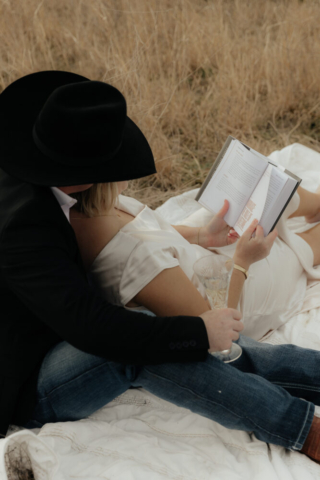 A couple in neutral attire run in an open field take their cinematic and documentary style engagement photos by Hannah Lylene Photography.