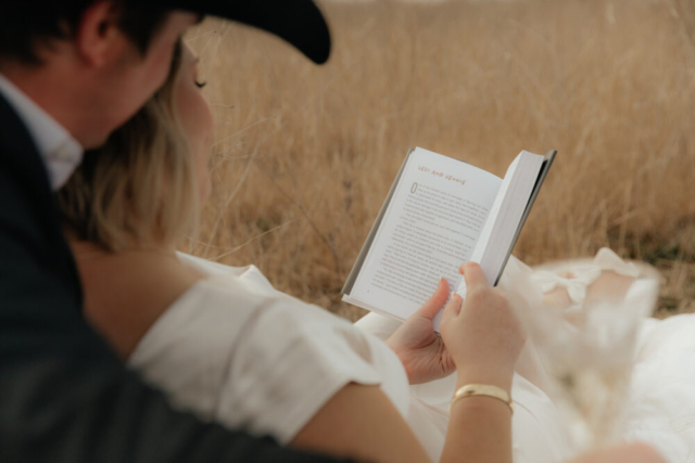 A couple in neutral attire run in an open field take their cinematic and documentary style engagement photos by Hannah Lylene Photography.