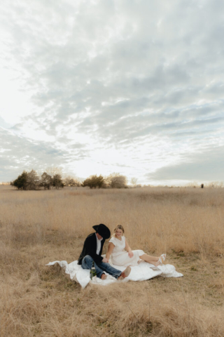 A couple in neutral attire run in an open field take their cinematic and documentary style engagement photos by Hannah Lylene Photography.